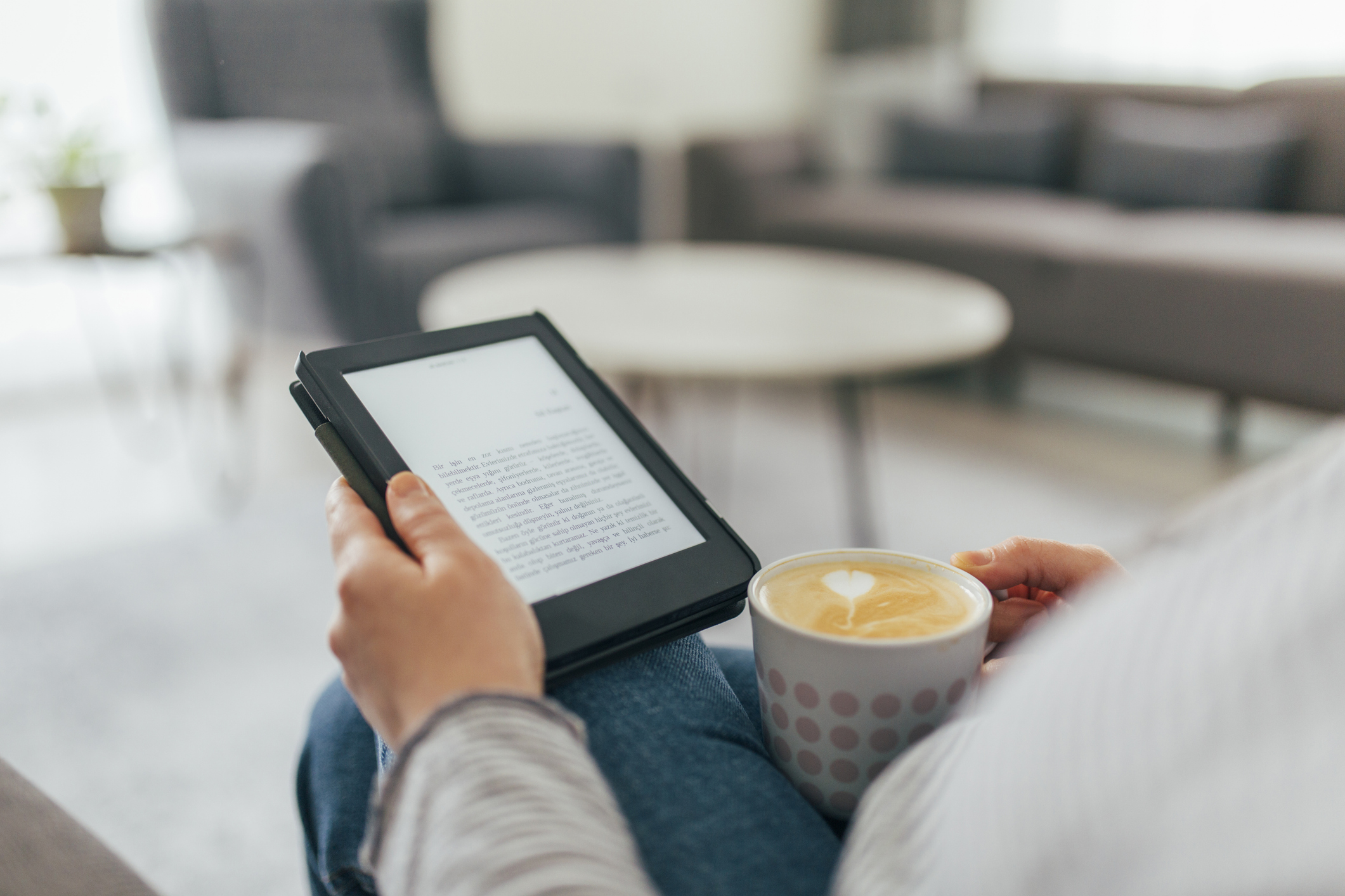 Person sitting down and reading on an ebook reader device