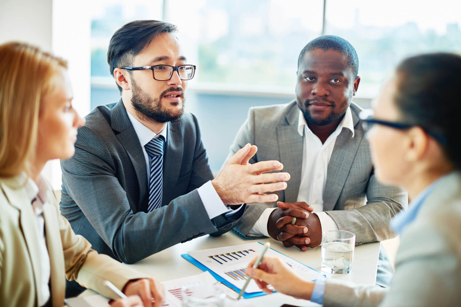 Group of professionals sitting together in office meeting room