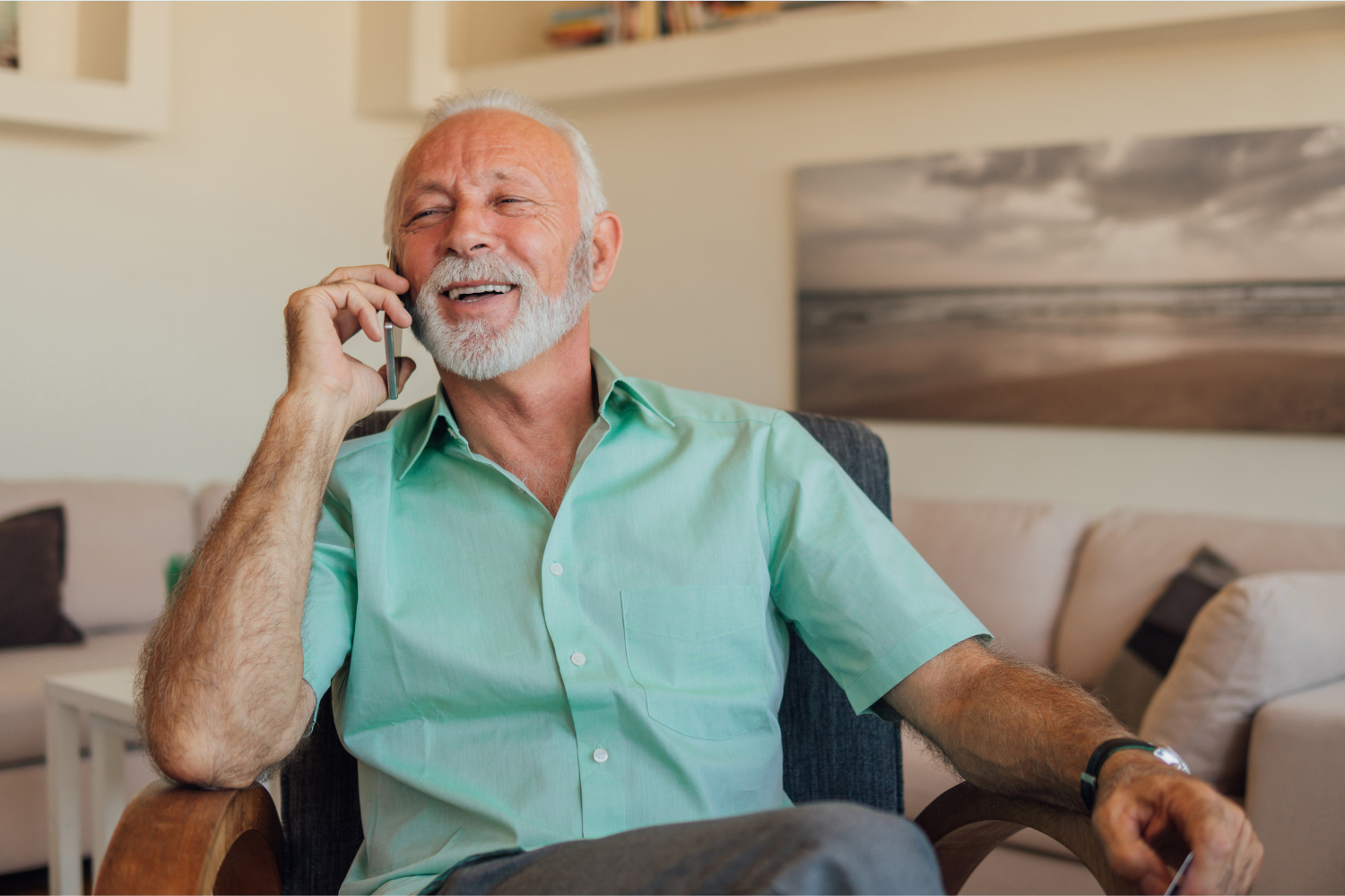 Man on the phone smiling and sitting